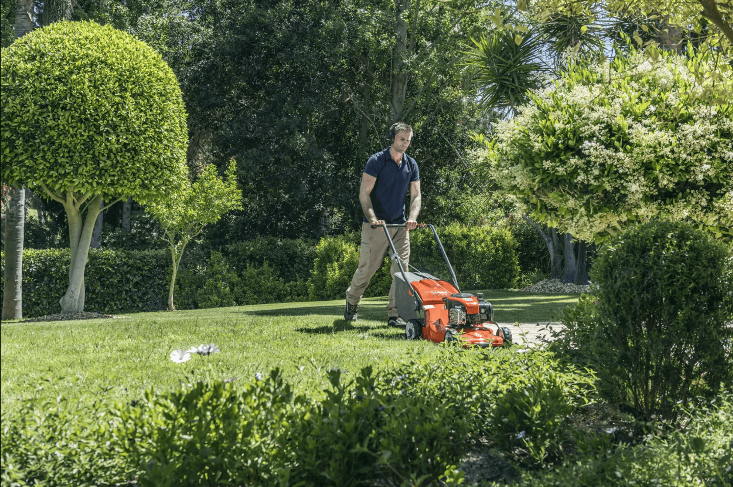 man in backyard with mower